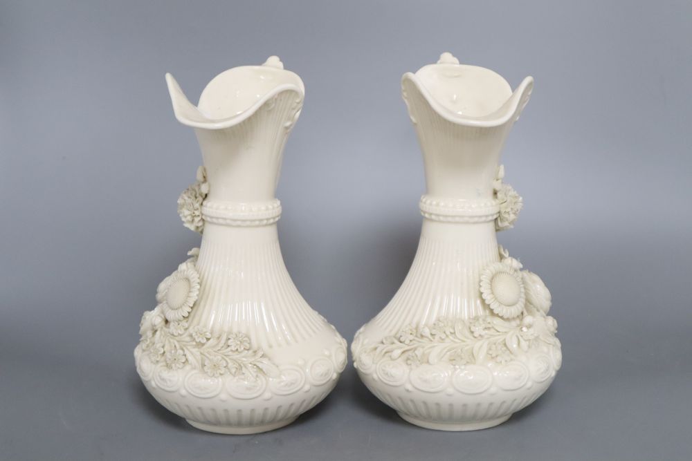 A pair of Belleek ewers, second period, height 23cm